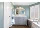 Stylish bathroom featuring a marble-topped vanity, soaking tub, and modern fixtures at 5 Rampart Ct, Henderson, NV 89074