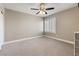 This bedroom features a ceiling fan, a bright window, a neutral wall color, and a closet at 5 Rampart Ct, Henderson, NV 89074