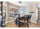 Cozy dining area with rustic wood table set and multiple windows providing natural light at 5 Rampart Ct, Henderson, NV 89074