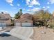 This home features a three-car garage, a front yard, and a driveway, and it is well maintained at 5 Rampart Ct, Henderson, NV 89074