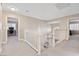 Upstairs hallway with carpet and white railing, leading to bedrooms and other living spaces at 5 Rampart Ct, Henderson, NV 89074