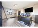 Spacious home office featuring a large desk, multiple monitors, and a window with a view of the neighborhood at 5 Rampart Ct, Henderson, NV 89074