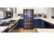 Modern kitchen featuring stainless steel appliances, white countertops, and blue cabinets at 5 Rampart Ct, Henderson, NV 89074