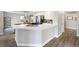 Kitchen island with quartz countertops, stainless steel sink, and ample storage space at 5 Rampart Ct, Henderson, NV 89074