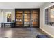 Stylish library with built-in bookshelves, rolling ladder and exterior views at 5 Rampart Ct, Henderson, NV 89074