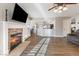 Bright living room featuring a fireplace, hardwood floors, and an open view to the kitchen and dining area at 5 Rampart Ct, Henderson, NV 89074