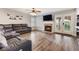 Cozy living room with fireplace, ceiling fan, modern furniture and view of the backyard at 5 Rampart Ct, Henderson, NV 89074