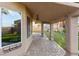 The covered patio features classic pavers, outdoor lighting, and views of the artificial grass backyard at 5 Rampart Ct, Henderson, NV 89074