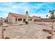Spacious backyard featuring stucco walls, desert landscaping, and a covered patio area, ideal for outdoor entertaining at 5033 Chambliss Dr, Las Vegas, NV 89130