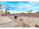 The private backyard features block walls, desert landscaping, and a charming paver walkway; ideal for relaxing outdoors at 5033 Chambliss Dr, Las Vegas, NV 89130