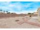 Desert backyard showcasing defined garden area, paver pathway, and privacy block wall, creating an oasis at 5033 Chambliss Dr, Las Vegas, NV 89130
