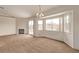 Bright dining area with carpet, a chandelier, and a bay window overlooking the backyard at 5033 Chambliss Dr, Las Vegas, NV 89130