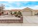 Charming single story home featuring a two car garage, landscaped yard, and a red tile roof at 5033 Chambliss Dr, Las Vegas, NV 89130