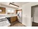 Bright kitchen with wood cabinets, tile countertops, and white appliances at 5033 Chambliss Dr, Las Vegas, NV 89130
