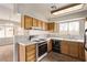 Traditional kitchen features wood cabinets, tile countertops, and adjacent dining area at 5033 Chambliss Dr, Las Vegas, NV 89130