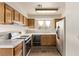 Kitchen features wood cabinets, tile countertops, and stainless steel refrigerator at 5033 Chambliss Dr, Las Vegas, NV 89130