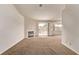 Open living room with a fireplace, sliding glass doors, plush carpeting and neutral paint at 5033 Chambliss Dr, Las Vegas, NV 89130