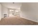 Bright living room with carpet, a fireplace, and a sliding glass door to the backyard at 5033 Chambliss Dr, Las Vegas, NV 89130