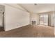 Spacious living room featuring plush carpeting, neutral paint, a fireplace, and a sliding glass door at 5033 Chambliss Dr, Las Vegas, NV 89130