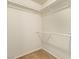 Empty walk-in closet with carpet flooring and white storage racks at 5033 Chambliss Dr, Las Vegas, NV 89130