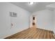 A bedroom with wood flooring and a window AC unit at 5044 Whistling Acres Ave, Las Vegas, NV 89131