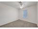 A standard bedroom with carpet, a ceiling fan, and a window at 5044 Whistling Acres Ave, Las Vegas, NV 89131