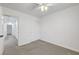 Carpeted bedroom features closet, ceiling fan, and neutral color palette at 5044 Whistling Acres Ave, Las Vegas, NV 89131