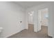 Upstairs hallway featuring carpet flooring and views into adjacent bedrooms at 5044 Whistling Acres Ave, Las Vegas, NV 89131