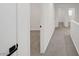 Upstairs hallway with doors leading to the bedrooms and neutral-colored carpet at 5044 Whistling Acres Ave, Las Vegas, NV 89131