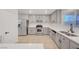 Bright kitchen with gray cabinets, stainless steel appliances, and light countertops at 5044 Whistling Acres Ave, Las Vegas, NV 89131