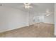 Spacious living room with neutral tile flooring and modern ceiling fan at 5044 Whistling Acres Ave, Las Vegas, NV 89131