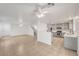 Open-concept living room and kitchen with tile flooring and stainless steel appliances at 5044 Whistling Acres Ave, Las Vegas, NV 89131