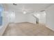Bright living room with tile flooring, ceiling fan, staircase, and a view of the front door at 5044 Whistling Acres Ave, Las Vegas, NV 89131
