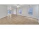Bright, open living area featuring tile floors, ceiling fans, and sliding glass doors to backyard at 5044 Whistling Acres Ave, Las Vegas, NV 89131