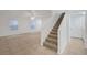 Bright staircase leading to the upper level with carpeted steps at 5044 Whistling Acres Ave, Las Vegas, NV 89131