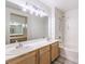 Bright bathroom featuring double sinks, bathtub, and new lighting at 51 E Agate Ave # 205, Las Vegas, NV 89123