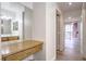 Hallway leading to a spacious bedroom and vanity with views of the balcony at 51 E Agate Ave # 205, Las Vegas, NV 89123