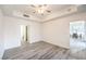 Open bedroom with neutral walls, hardwood flooring, a ceiling fan, and a walk-in closet at 51 E Agate Ave # 205, Las Vegas, NV 89123