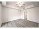 Spacious bedroom with bright white walls, ceiling fan and light hardwood flooring at 51 E Agate Ave # 205, Las Vegas, NV 89123