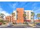 Multi-story building featuring sleek, modern architecture, palm trees, and convenient parking spaces at 51 E Agate Ave # 205, Las Vegas, NV 89123