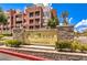 Elegant stone sign for Park Avenue Condominiums with well-maintained landscaping and a clear blue sky at 51 E Agate Ave # 205, Las Vegas, NV 89123
