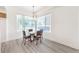 Dining area with hardwood style floors, modern lighting, and a view from the window at 51 E Agate Ave # 205, Las Vegas, NV 89123