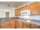 Kitchen showcasing granite countertops, light wood cabinets, and stainless steel appliances at 51 E Agate Ave # 205, Las Vegas, NV 89123