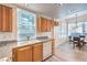 Kitchen features wood cabinets, white appliances, granite counters, and a dining area at 51 E Agate Ave # 205, Las Vegas, NV 89123