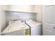 A convenient laundry room area with a washer and dryer set and some shelving for storage at 51 E Agate Ave # 205, Las Vegas, NV 89123