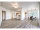 Spacious living room with ceiling fan, grey wood floors, open kitchen and dining room and doors at 51 E Agate Ave # 205, Las Vegas, NV 89123