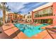 Resort-style swimming pool and lounge area surrounded by lush landscaping and upscale residential buildings at 51 E Agate Ave # 205, Las Vegas, NV 89123