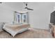 Bedroom with a ceiling fan, carpet flooring, and plenty of natural light at 5398 Pico Viejo St, Las Vegas, NV 89166