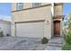 Charming home with a large garage door, brick driveway, and tiled roof at 5398 Pico Viejo St, Las Vegas, NV 89166