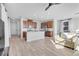 Open-concept kitchen with a breakfast bar and modern appliances, complemented by hardwood floors and plenty of light at 5398 Pico Viejo St, Las Vegas, NV 89166